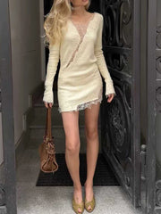 Model wearing a white lace V-neck long sleeve mini dress outdoors
