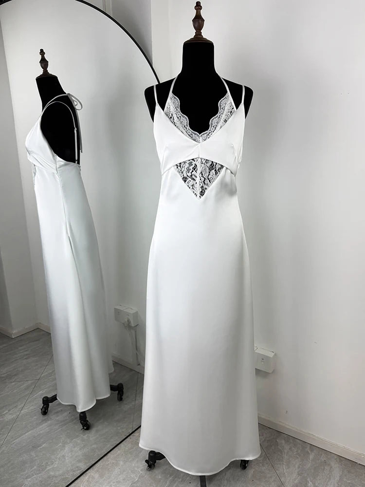 White satin nightgown with lace details on a mannequin against a white wall.