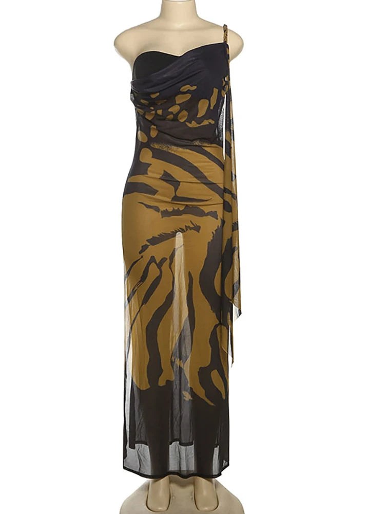 Black and gold patterned dress on a mannequin against a white background