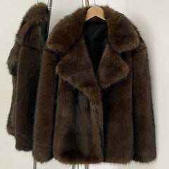 Brown fur coat on a hanger against a white background