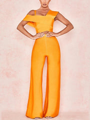 Orange jumpsuit worn by a model on a pink background