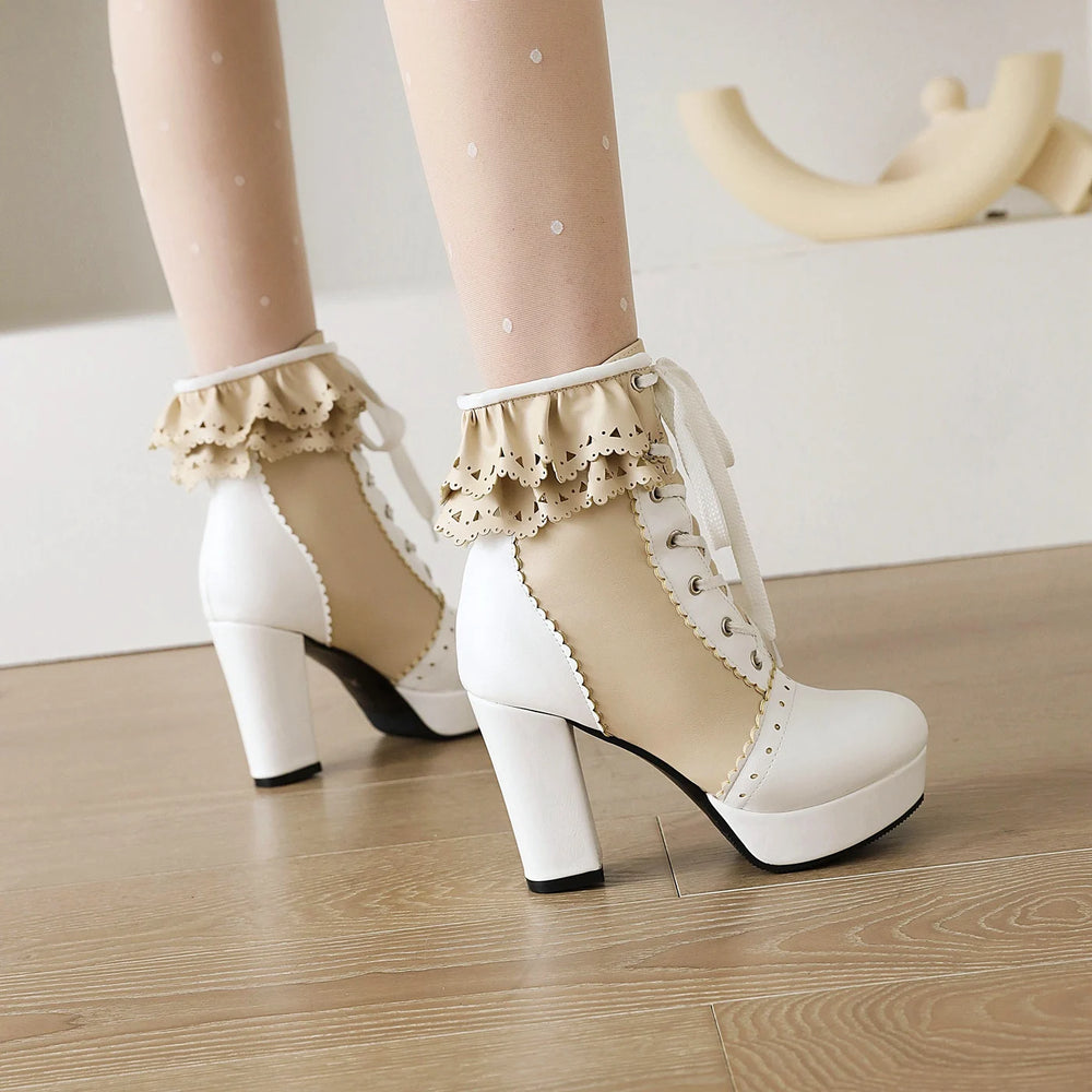 White platform shoes with lace details worn indoors on a wooden floor.
