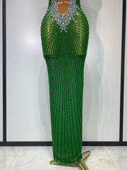 Green beaded evening gown on a mannequin against a white background