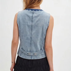 Back view of a light wash denim vest with adjustable tabs.
