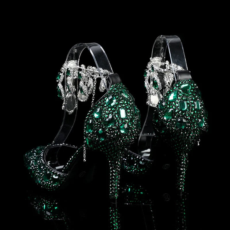 Green high-heeled shoes with sparkling embellishments on a black background