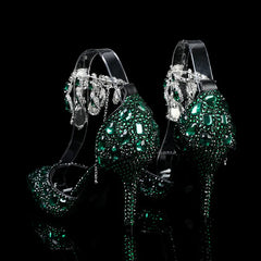 Green high-heeled shoes with sparkling embellishments on a black background