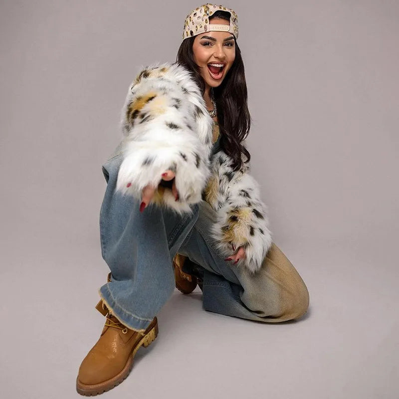 Person wearing a snow leopard costume with a gray background