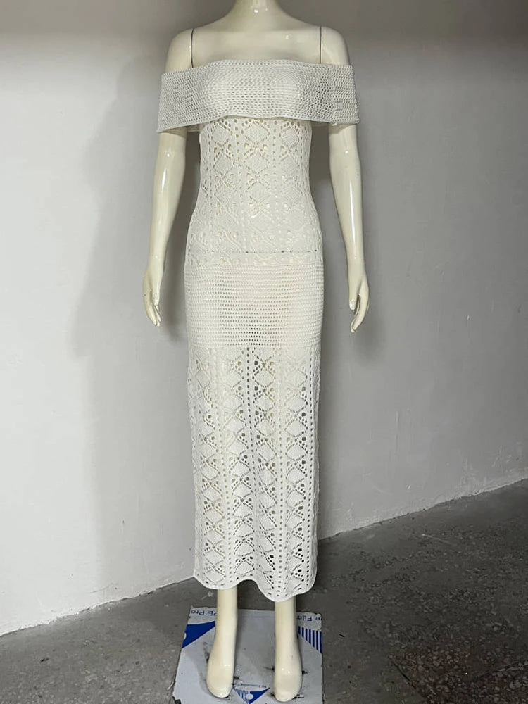 Mannequin wearing a white off-shoulder dress with intricate lace detailing against a plain background.