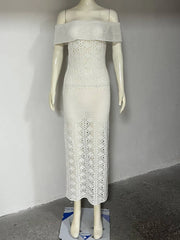 Mannequin wearing a white off-shoulder dress with intricate lace detailing against a plain background.