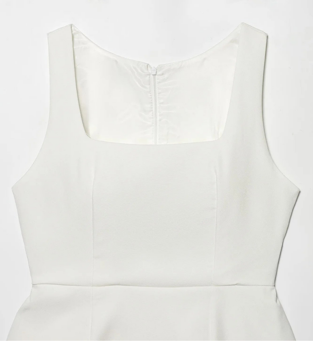 White sleeveless dress on a light gray background