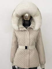 Beige quilted jacket with large fur hood on a mannequin against a white background