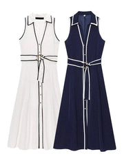 Two sleeveless dresses, one white and one navy with black polka dots,