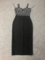 Black dress with silver embellishments on a gray background