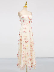 White dress with floral embellishments on a mannequin against a white background