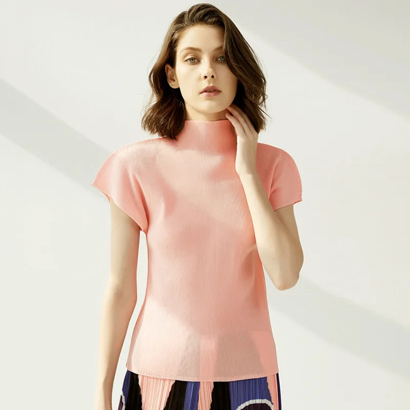 Woman wearing a pink top against a white background