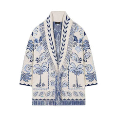 White cardigan with blue paisley pattern on a white background