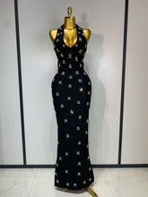 Halter neck sleeveless ankle-length knit bodycon gown with scattered diamond embellishments, front view.