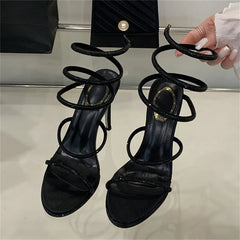 Black crystal spiral high heel sandals being held