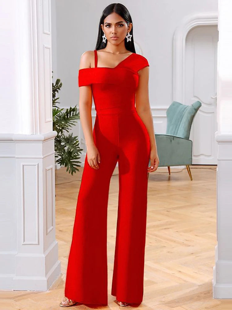 Woman wearing a red jumpsuit in an elegant room with white walls and wooden floor.