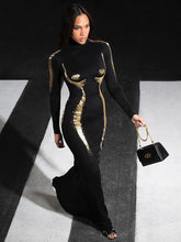 Woman in a black and gold dress holding a handbag on a black and white striped floor.