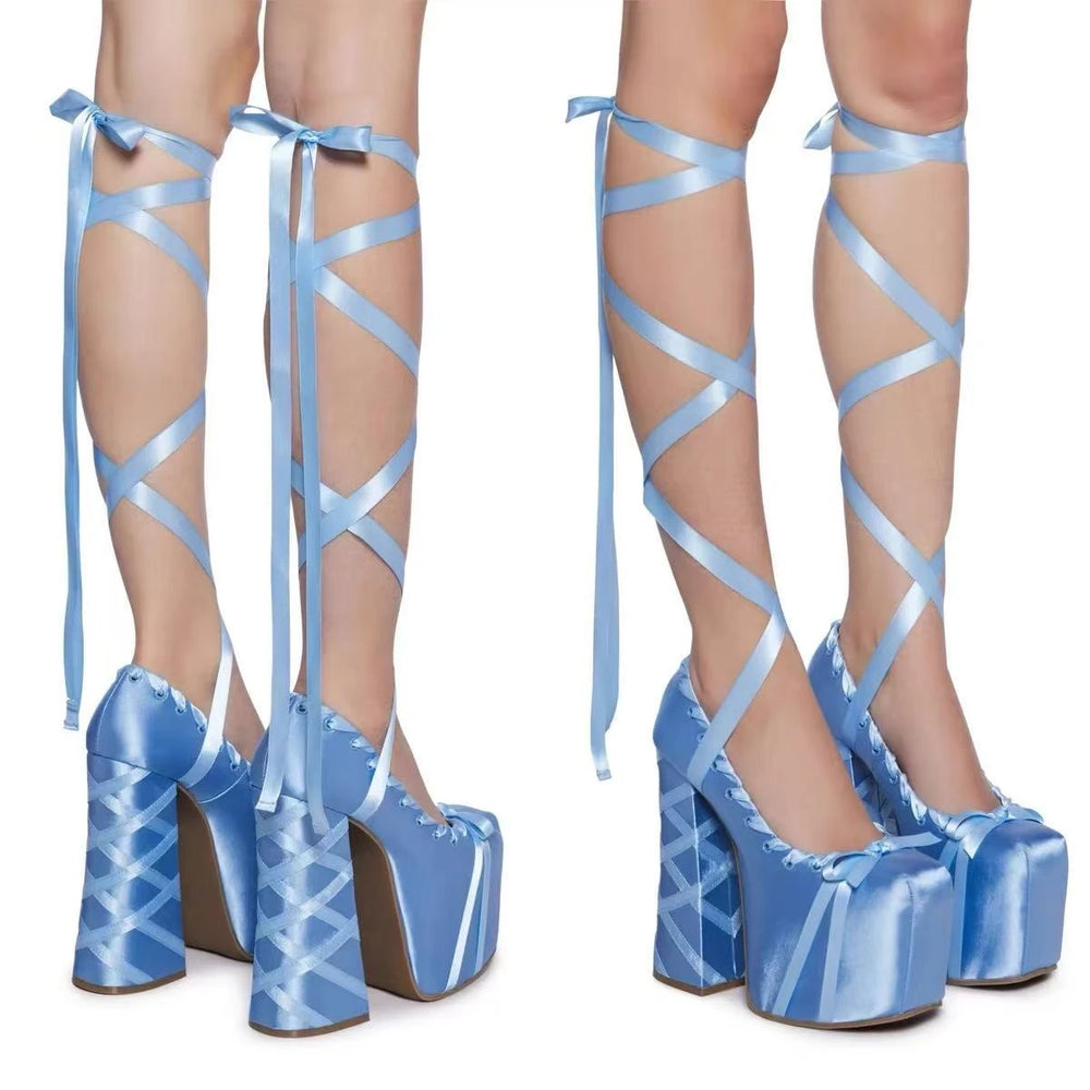Blue platform high heels with strappy design on a white background