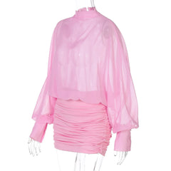 Pink ruched dress with sheer long-sleeve top on a white background