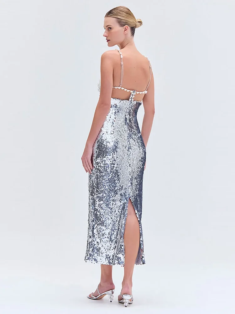 Woman wearing a silver sequin dress with a white background