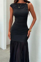 Black dress worn by a person against a neutral background