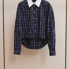 Blue plaid shirt with a white collar on a beige background