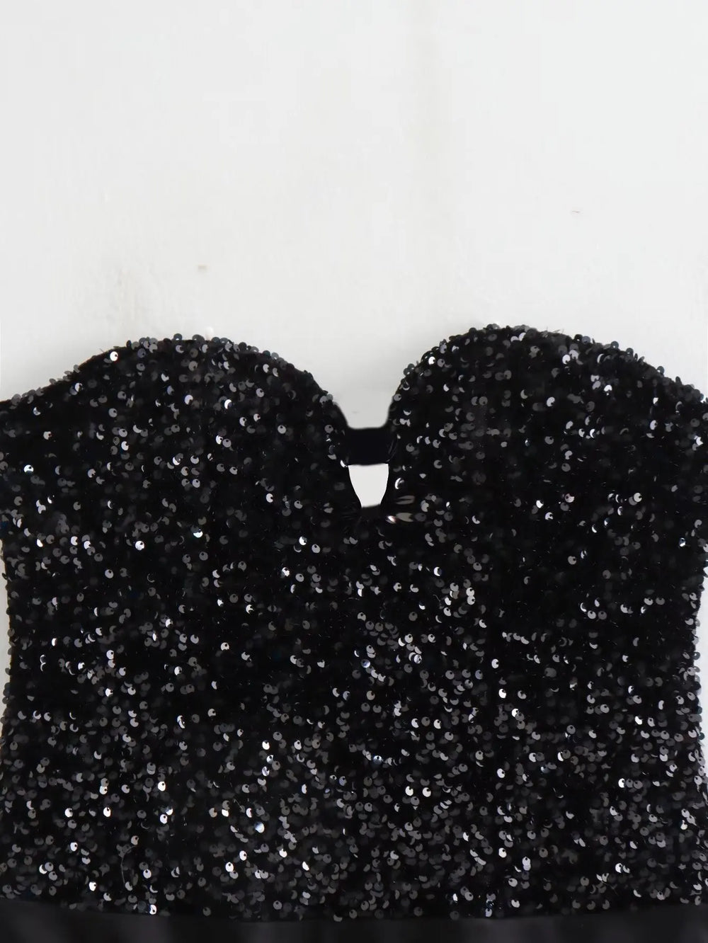 Black glittery top on a white background