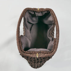 Brown woven handbag with gold zipper on a light gray background