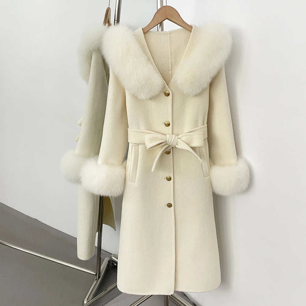 Cream wool coat with fox fur collar and cuffs, belted.