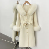 Cream wool coat with fox fur collar and cuffs, belted.