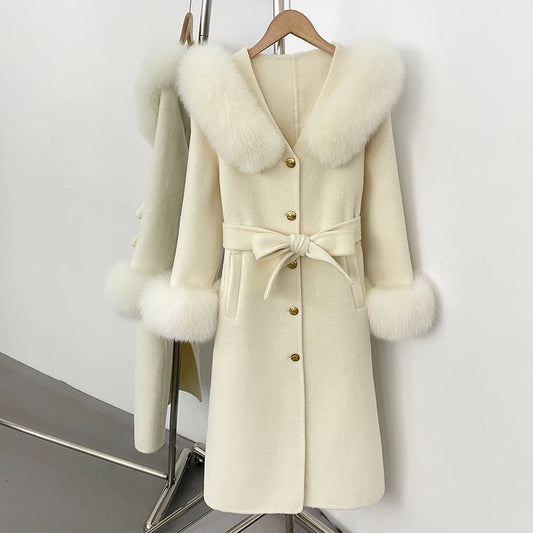 Cream wool coat with fox fur collar and cuffs, belted.