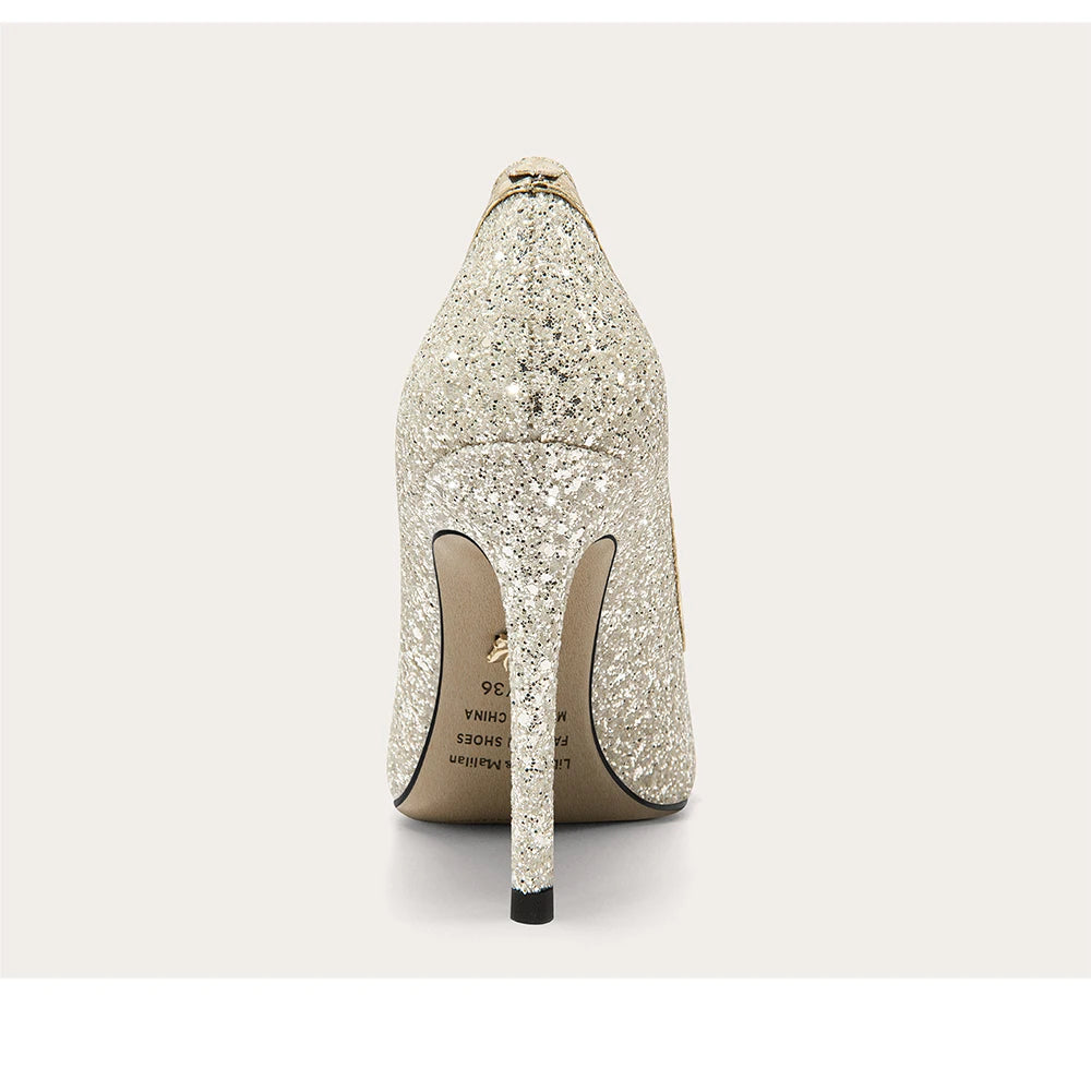 Sparkly high-heeled shoe on a light gray background