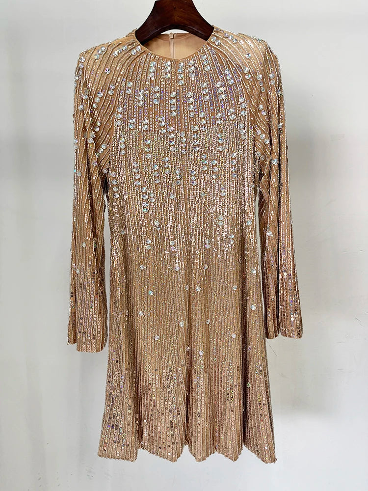 Front view of a gold beaded long sleeve mini dress on a hanger.