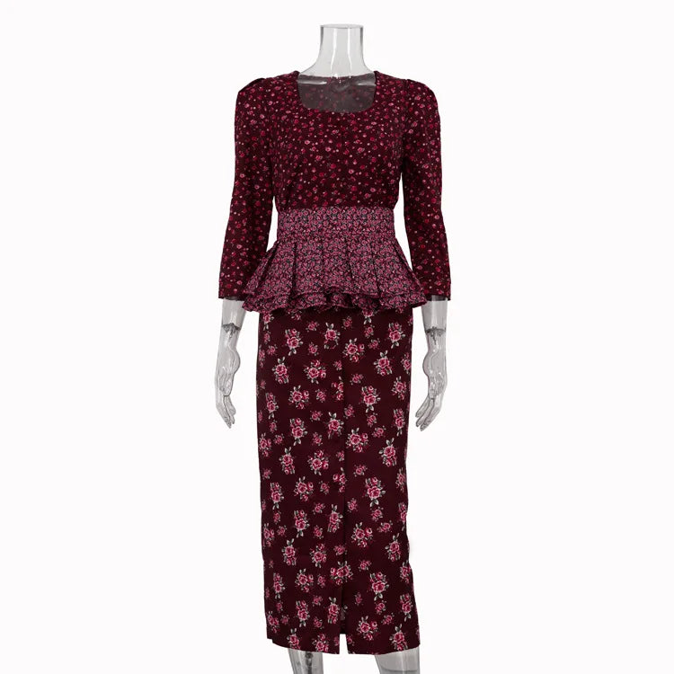 Mannequin wearing a maroon floral dress with a peplum top on a white background