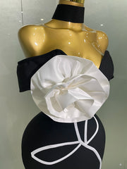 Black and white floral top on a mannequin against a neutral background
