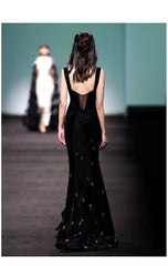 Black velvet mermaid maxi dress with spaghetti straps and beaded embellishments, back view.