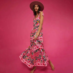 Person posing in a floral print swimwear set with a wide-brimmed hat.