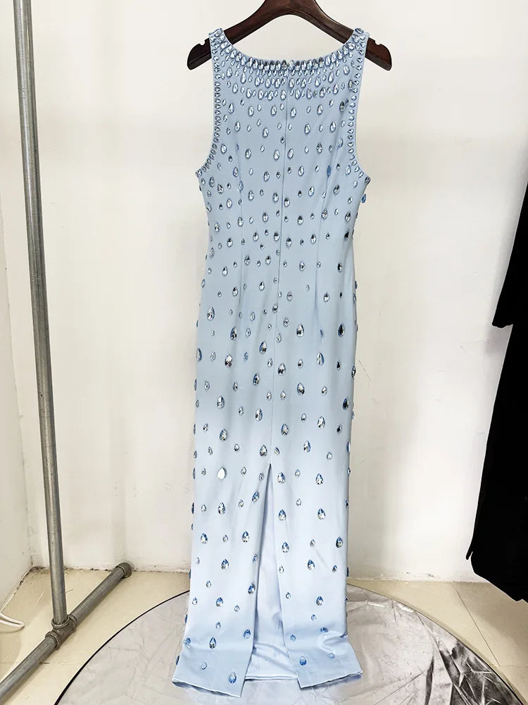 Light blue sleeveless dress with bead embellishments on a hanger against a white background