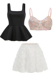 Black peplum top, pink lace bralette, and white ruffled skirt on a white background