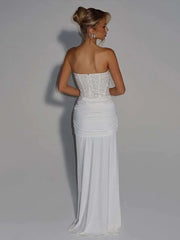 Woman wearing a strapless white evening gown- back view