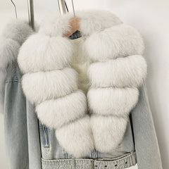 Denim jacket with a white fur vest on a plain background