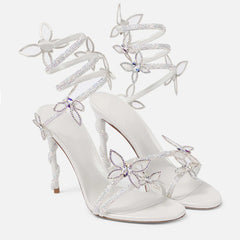 White high-heeled shoes with floral embellishments