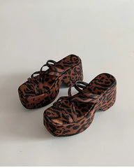 Leopard print platform sandals on a white background