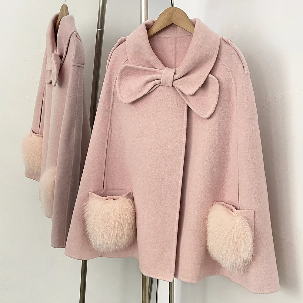 Detail of pink cape coat's bow and fur pocket