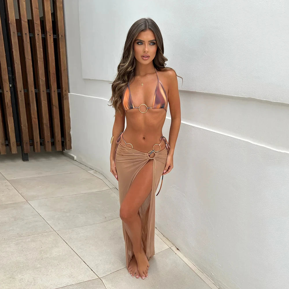 Printed triangle bikini top and matching bottoms with a flowing beige mesh maxi skirt.