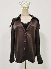 Brown satin shirt on a mannequin with a plain background