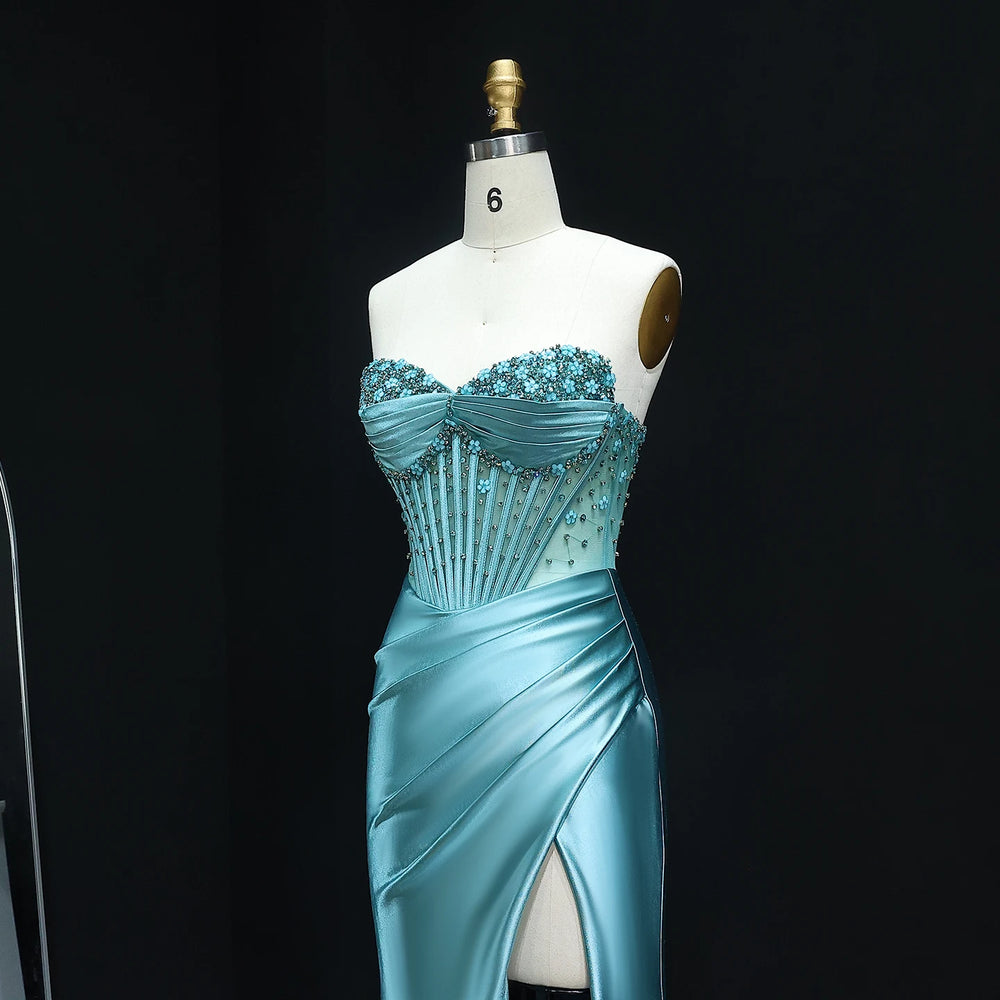 Teal evening gown on a mannequin against a black background